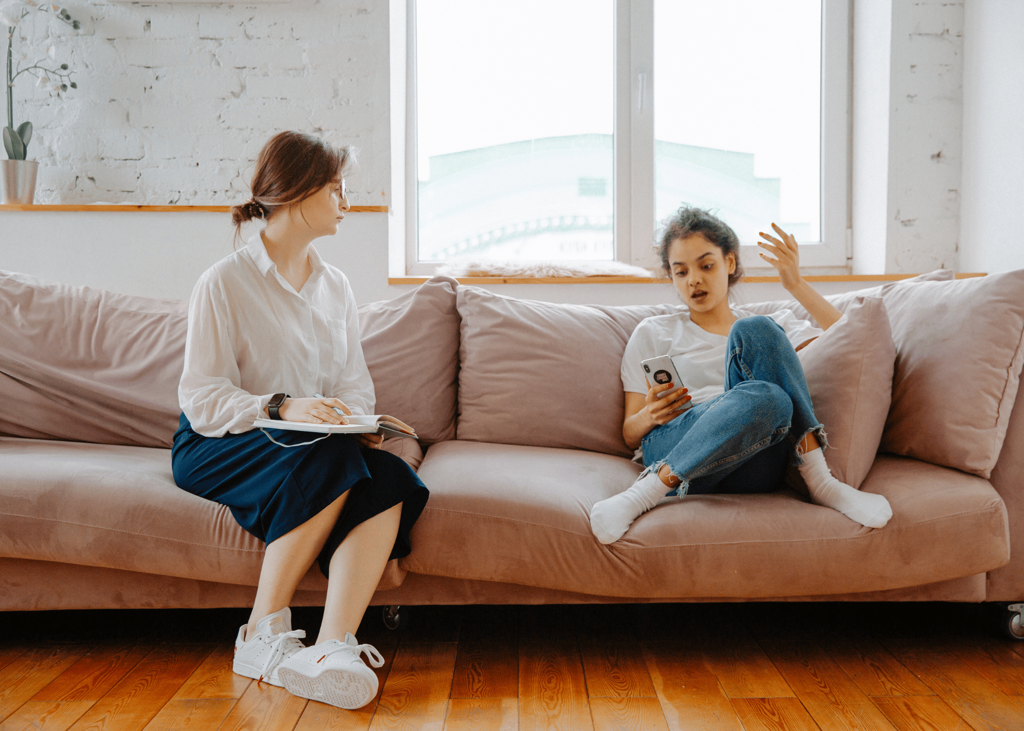 Client and therapist sitting on a couch in New York therapy office during transference-focused psychotherapy.